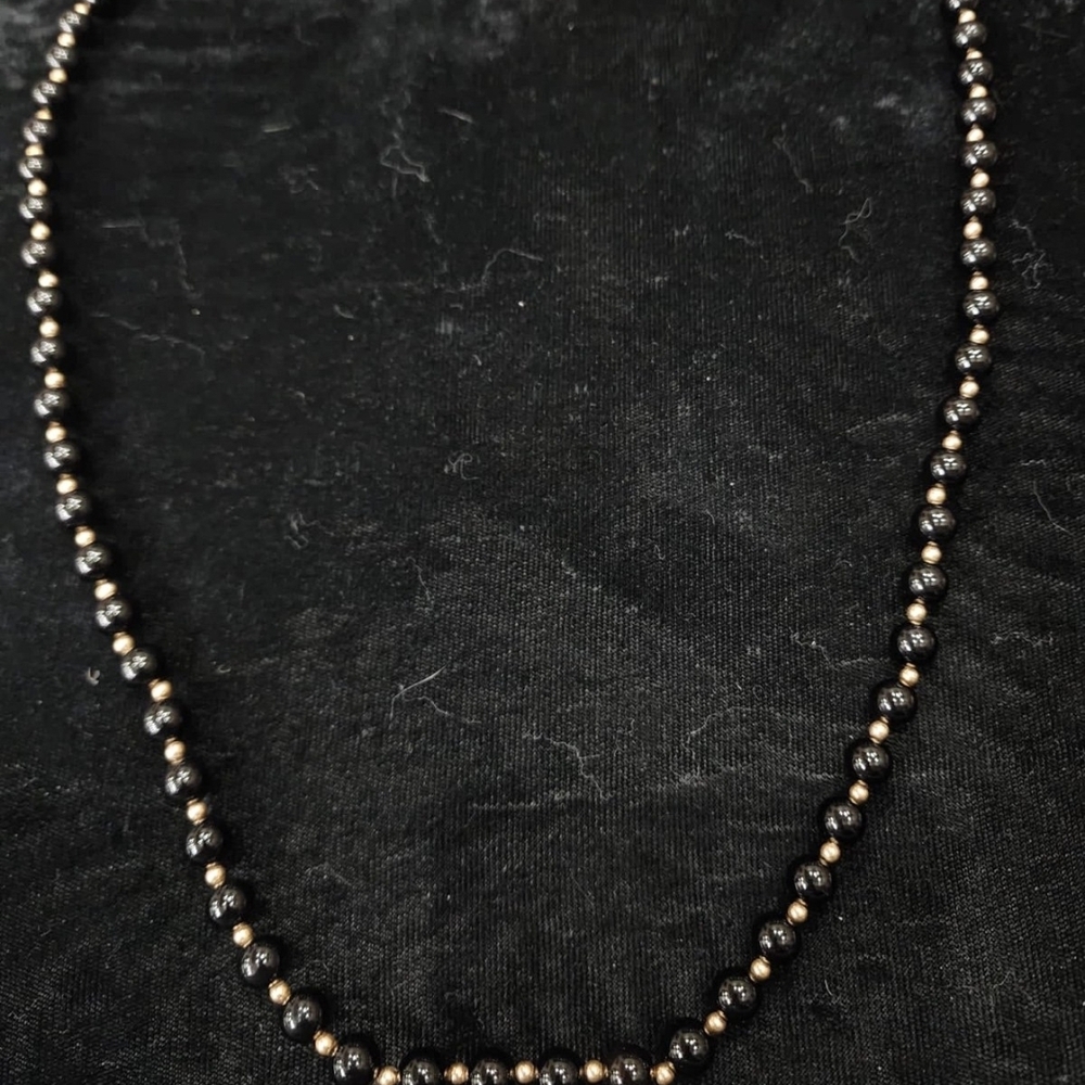 14K yellow gold onyx beaded necklace.